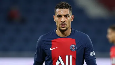 Mid-30s muscular Paris FC midfielder, intense gaze, sweat-glazed forehead, wearing a plain blue-red training top (solid...