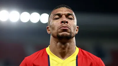 A close-up shot of a Paris FC player's face, with a mix of disappointment and determination, as he looks up at the sky...